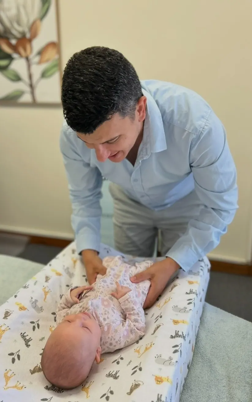 Dr Luke gently assessing a baby